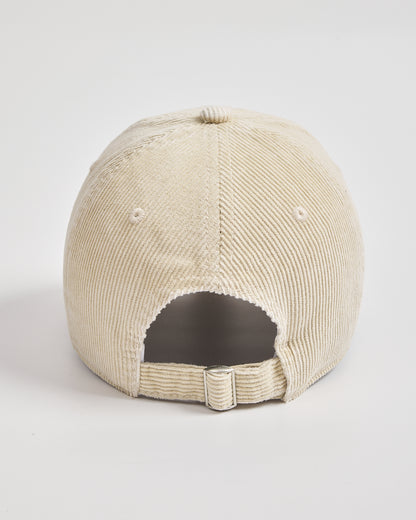 Cream corduroy cap on a light gray background