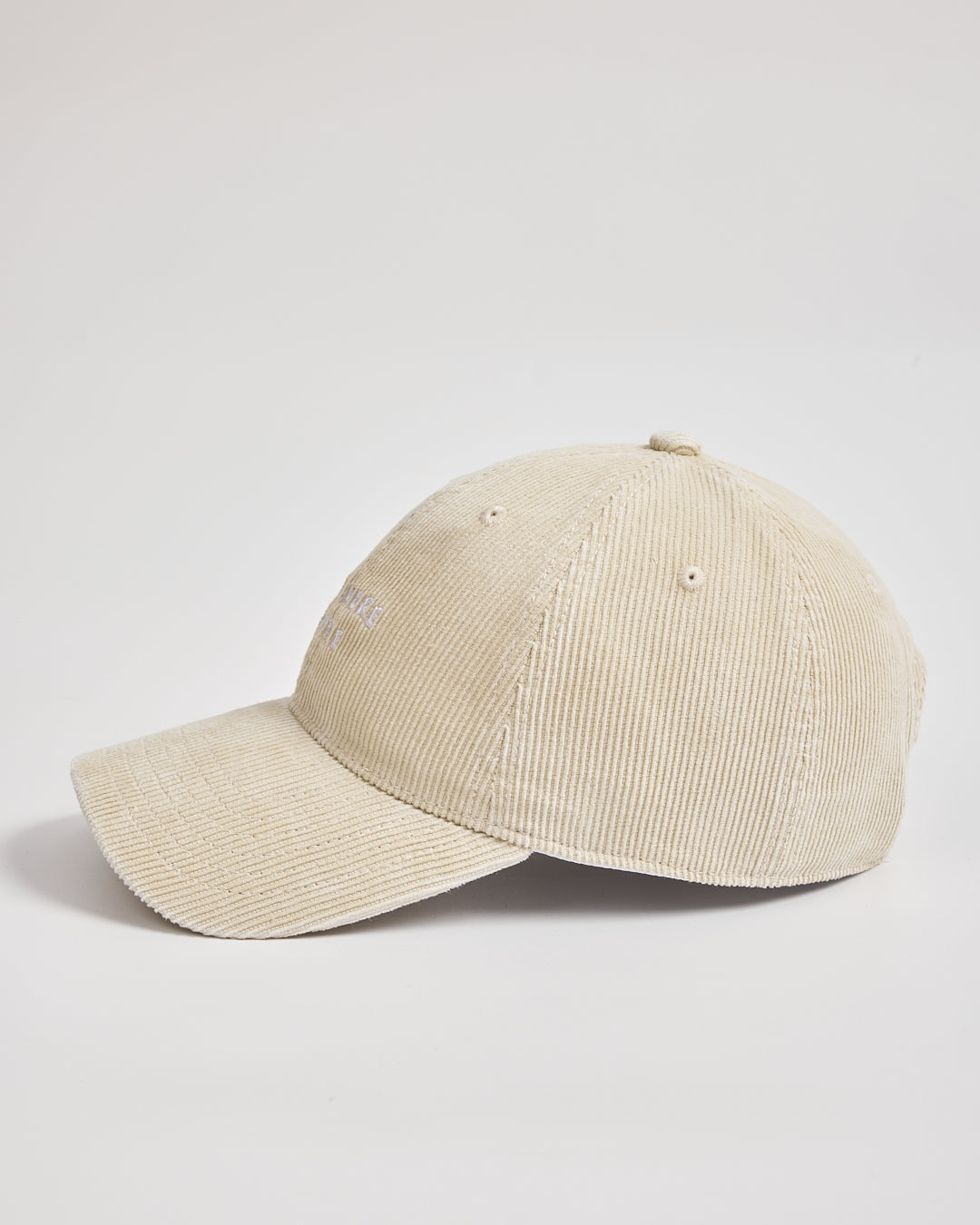 Cream corduroy cap on a light gray background