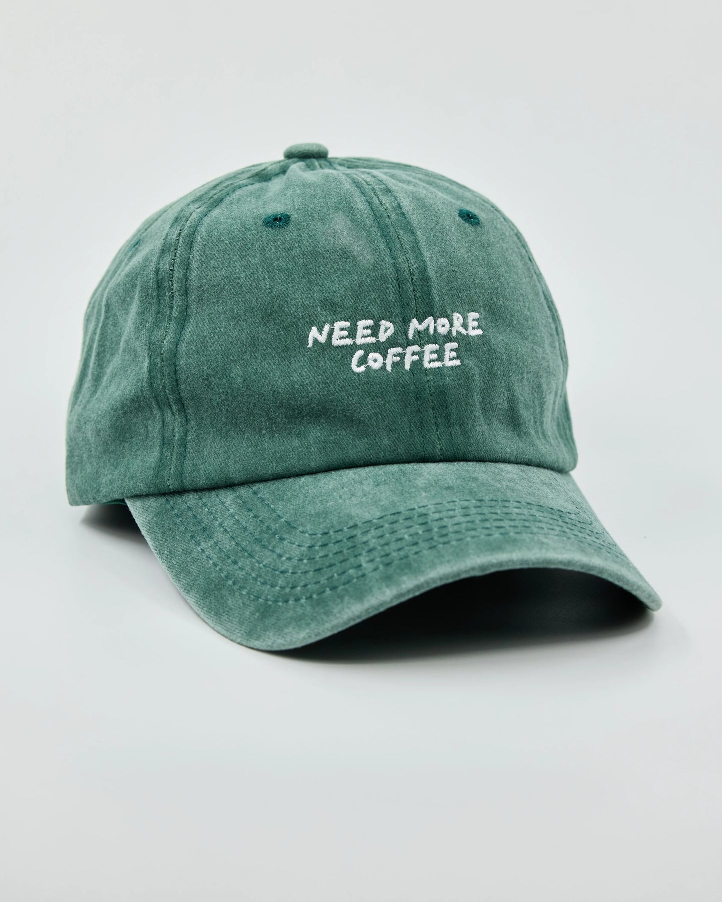 Side view of Need More Coffee Dark Green Washed Cap