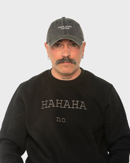 A man wearing the Need More Coffee Dark Grey Washed Cap