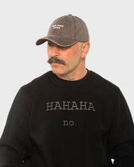 A man wearing the Need More Coffee Dusty Brown Washed Cap