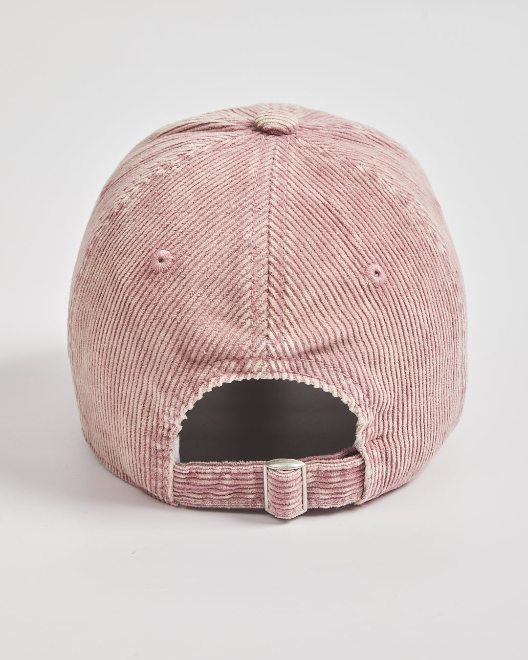 Pink corduroy cap on a light gray background