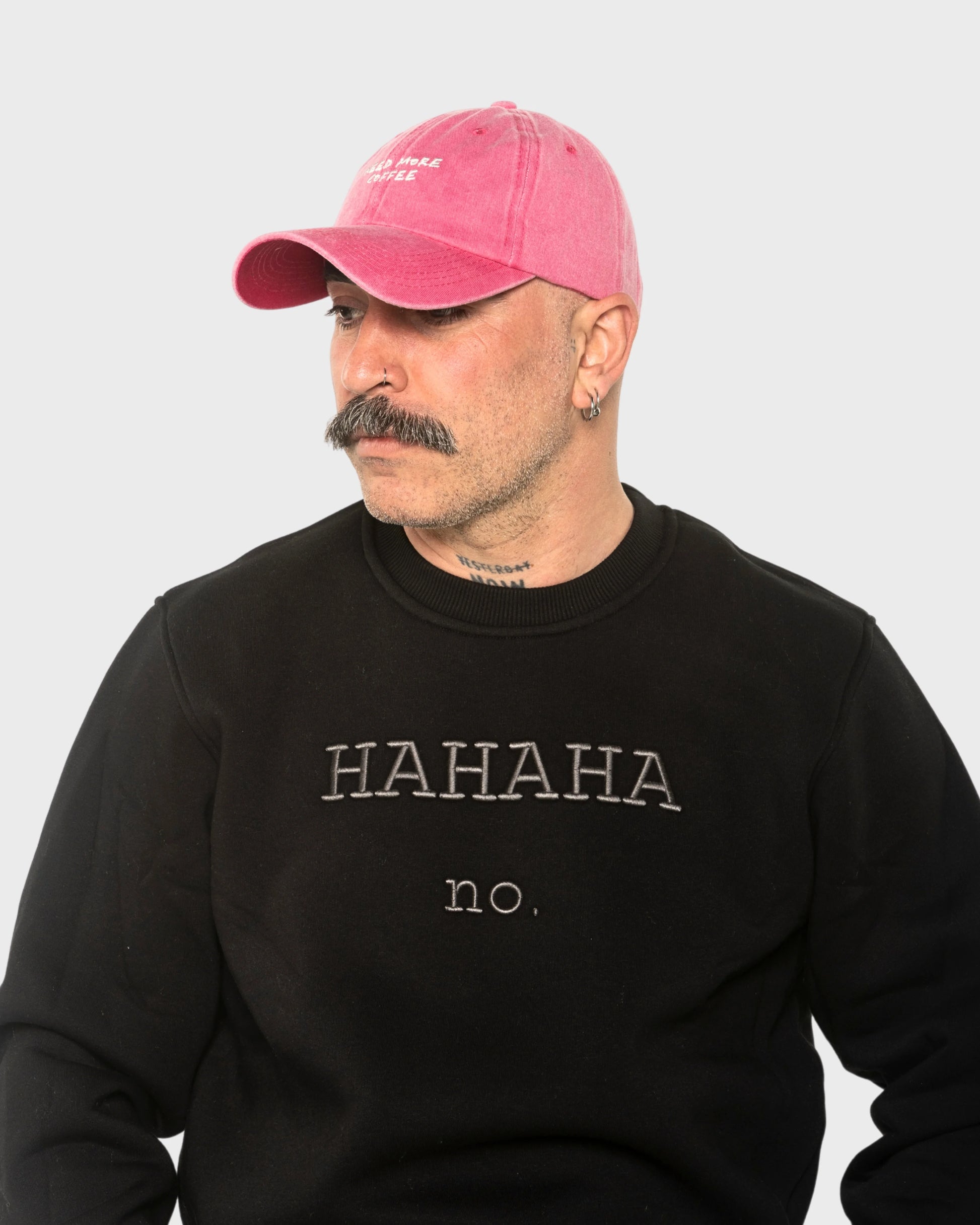 A man wearing the Need More Coffee Hot Pink Washed Cap