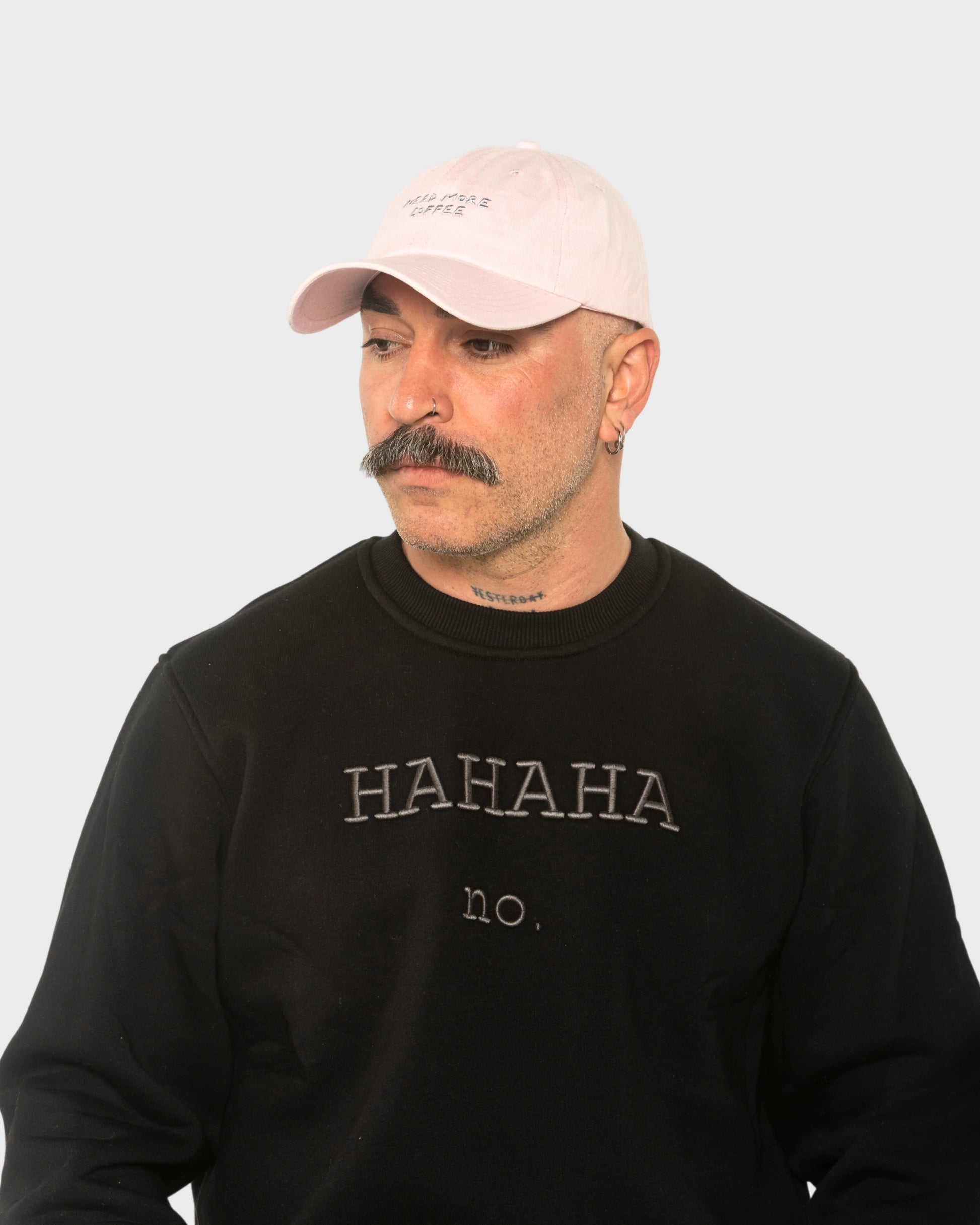 A man wearing the Need More Coffee Light Pink Washed Cap