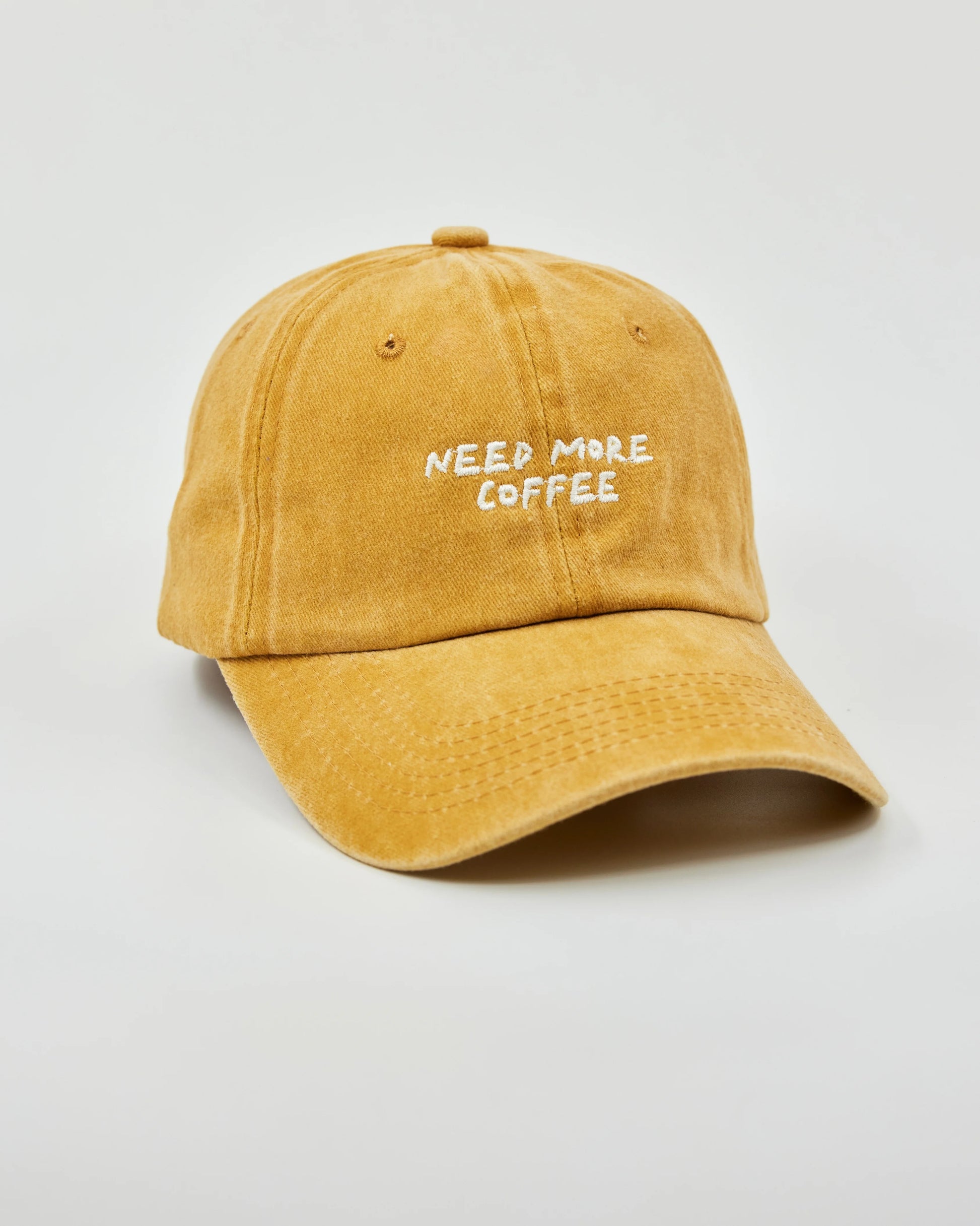 Side view of Need More Coffee Mustard Washed Cap