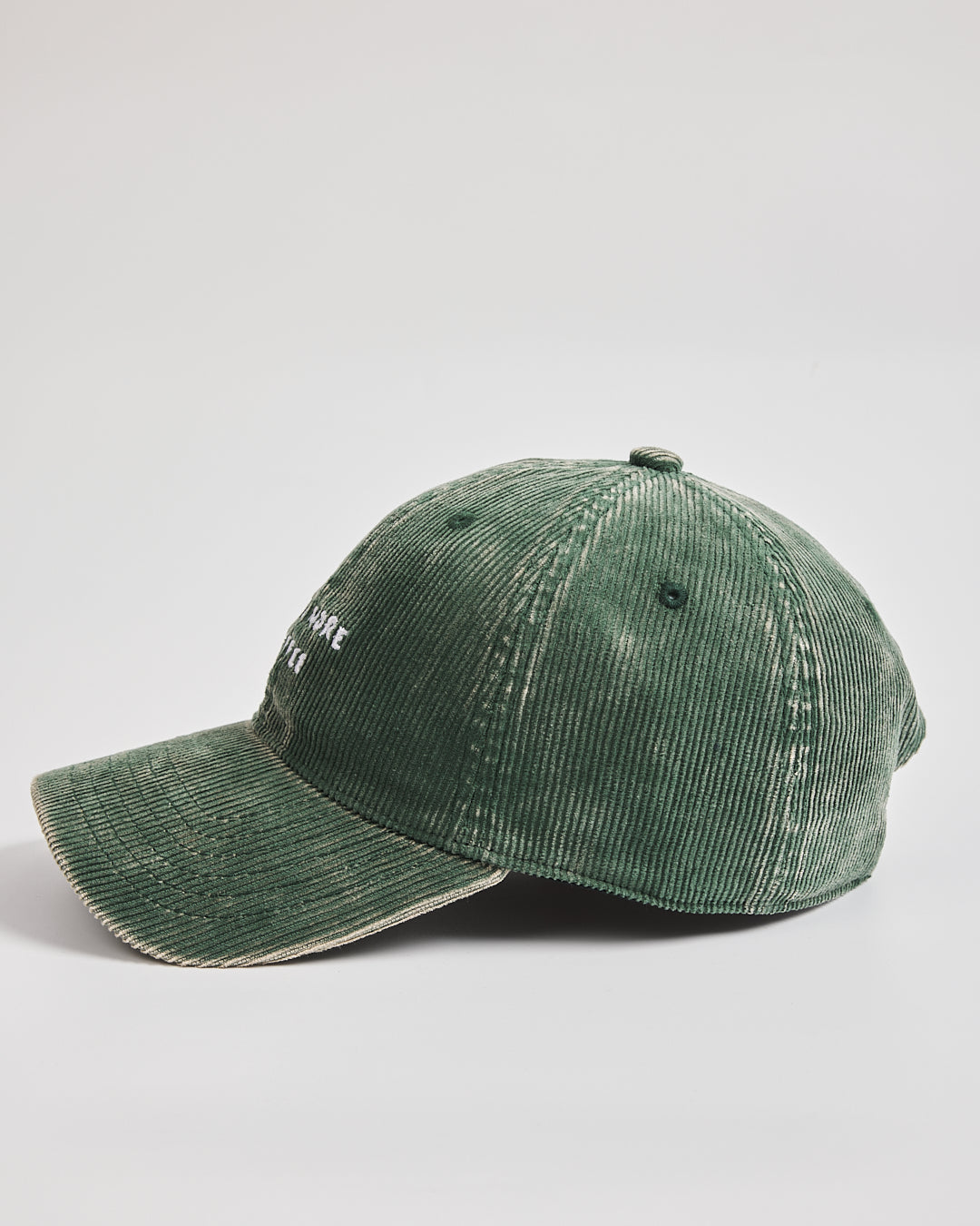 Green corduroy cap on a light gray background