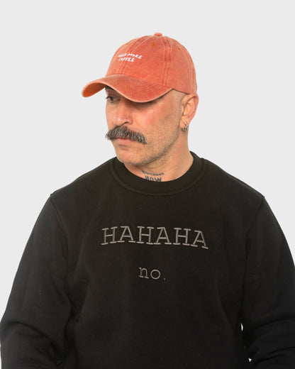 A man wearing the Need More Coffee Orange Washed Cap