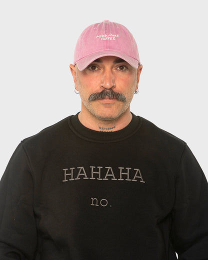 A man wearing the Need More Coffee Pink Washed Cap
