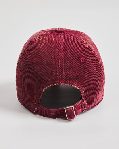 Maroon corduroy cap on a light gray background