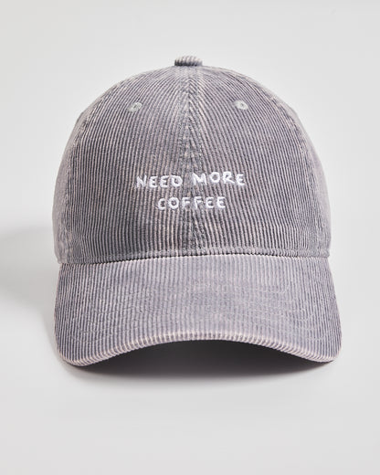 Gray corduroy cap with 'Need More Coffee' text on a light gray background