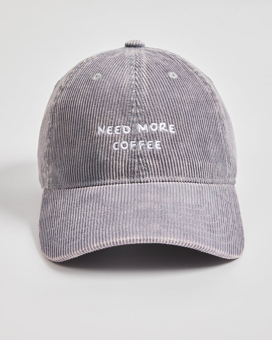 Gray corduroy cap with 'Need More Coffee' text on a light gray background