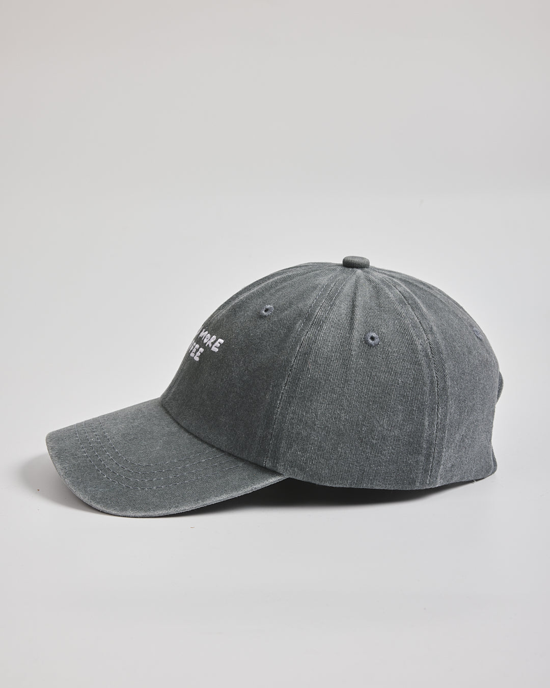 Need More Coffee Washed Grey Washed Cap on a light gray background
