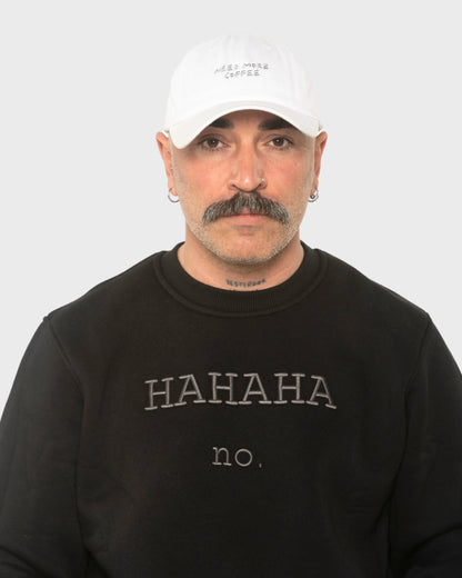 A man wearing the Need More Coffee White Washed Cap
