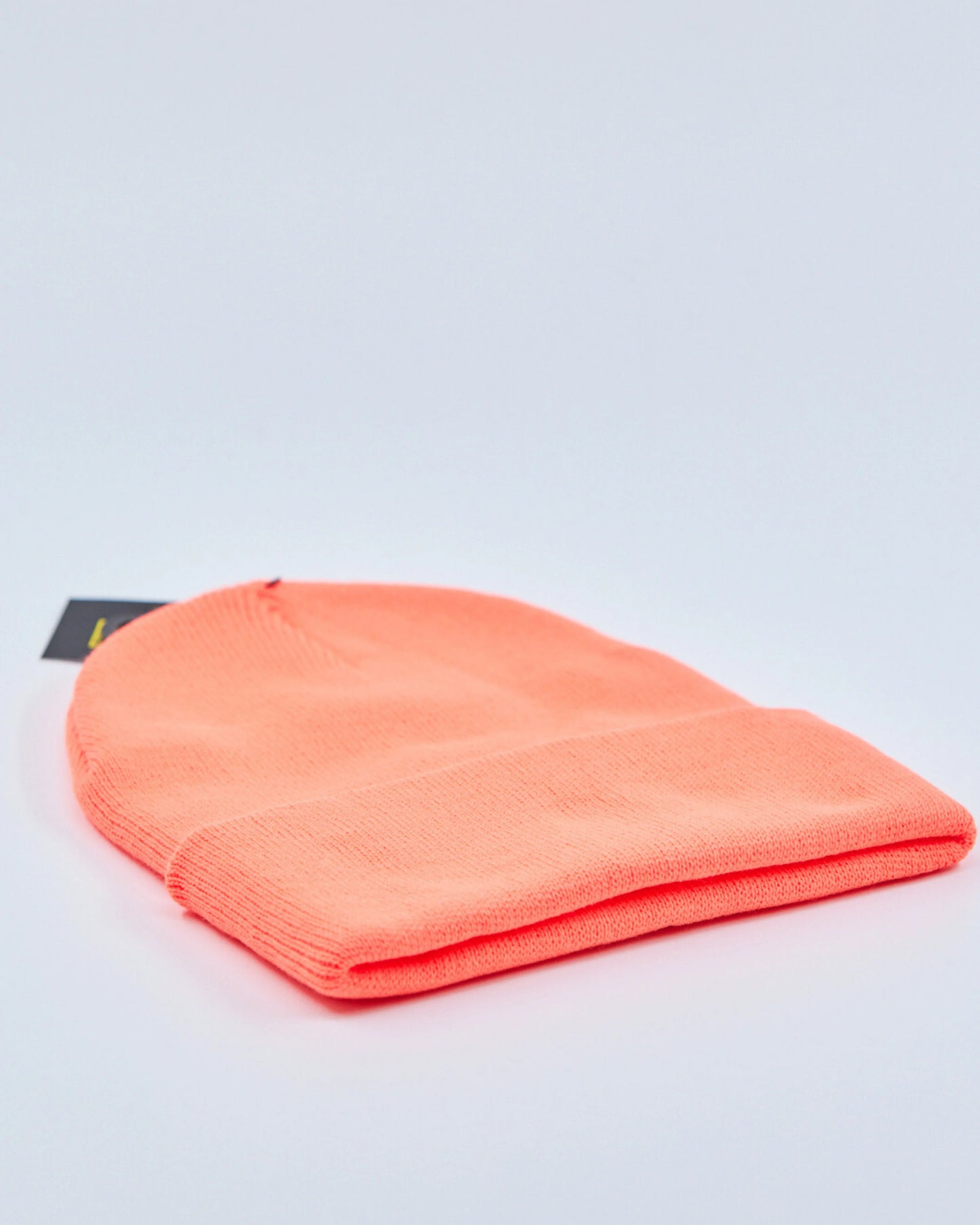 Neon orange beanie on a light gray background