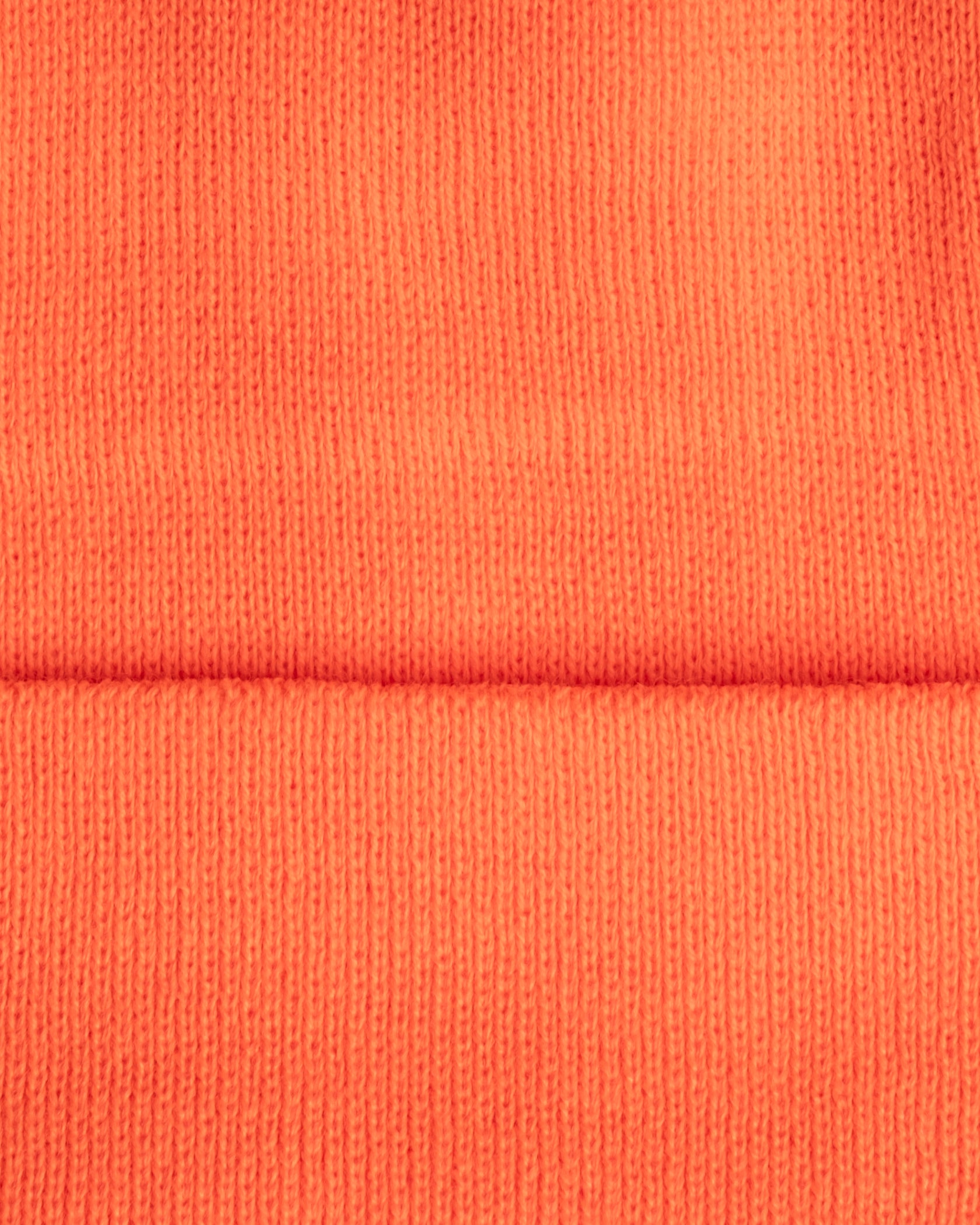 Close-up of orange fabric with a visible seam