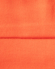 Close-up of orange fabric with a visible seam