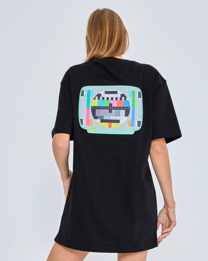Person wearing a black t-shirt with a colorful graphic on the back against a white background