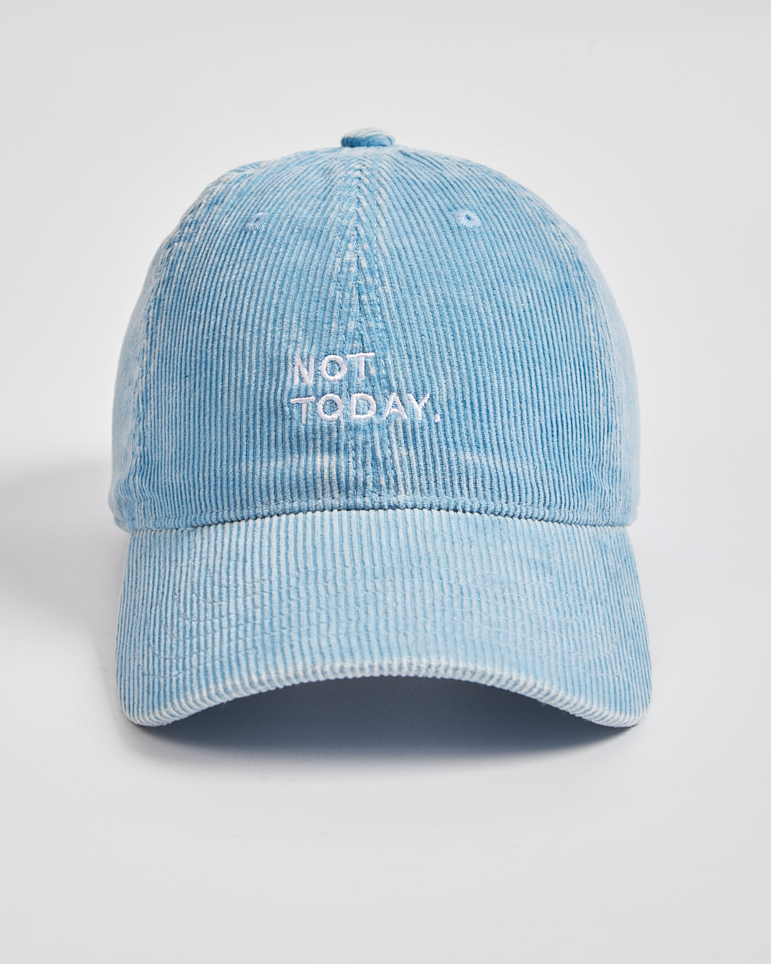 Blue corduroy cap with 'Not Today' text on a light gray background