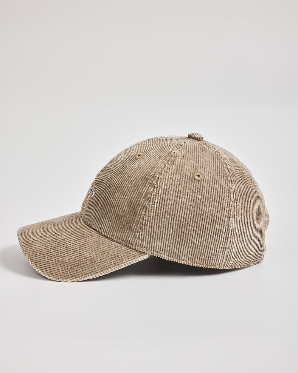 Beige corduroy cap on a light gray background