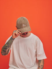 Person wearing a cap with 'Not Today' text on an orange background