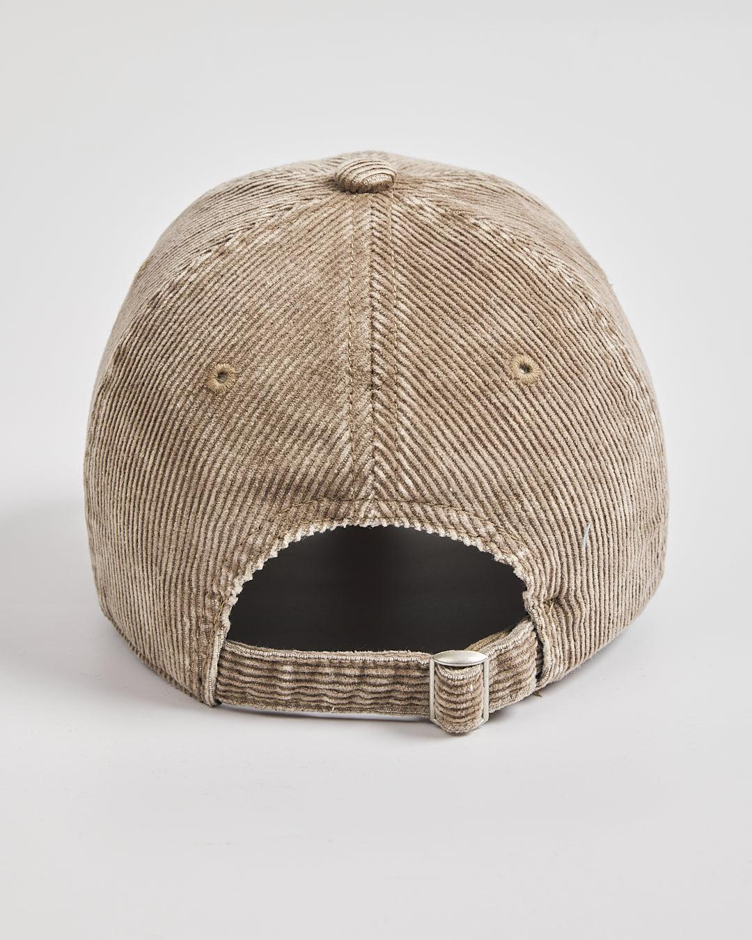 Beige corduroy cap on a light gray background
