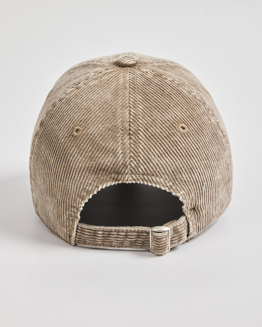 Beige corduroy cap on a light gray background