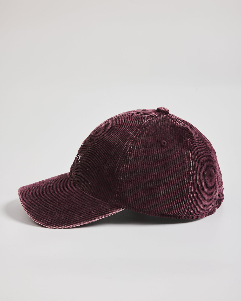 Maroon corduroy cap on a light gray background