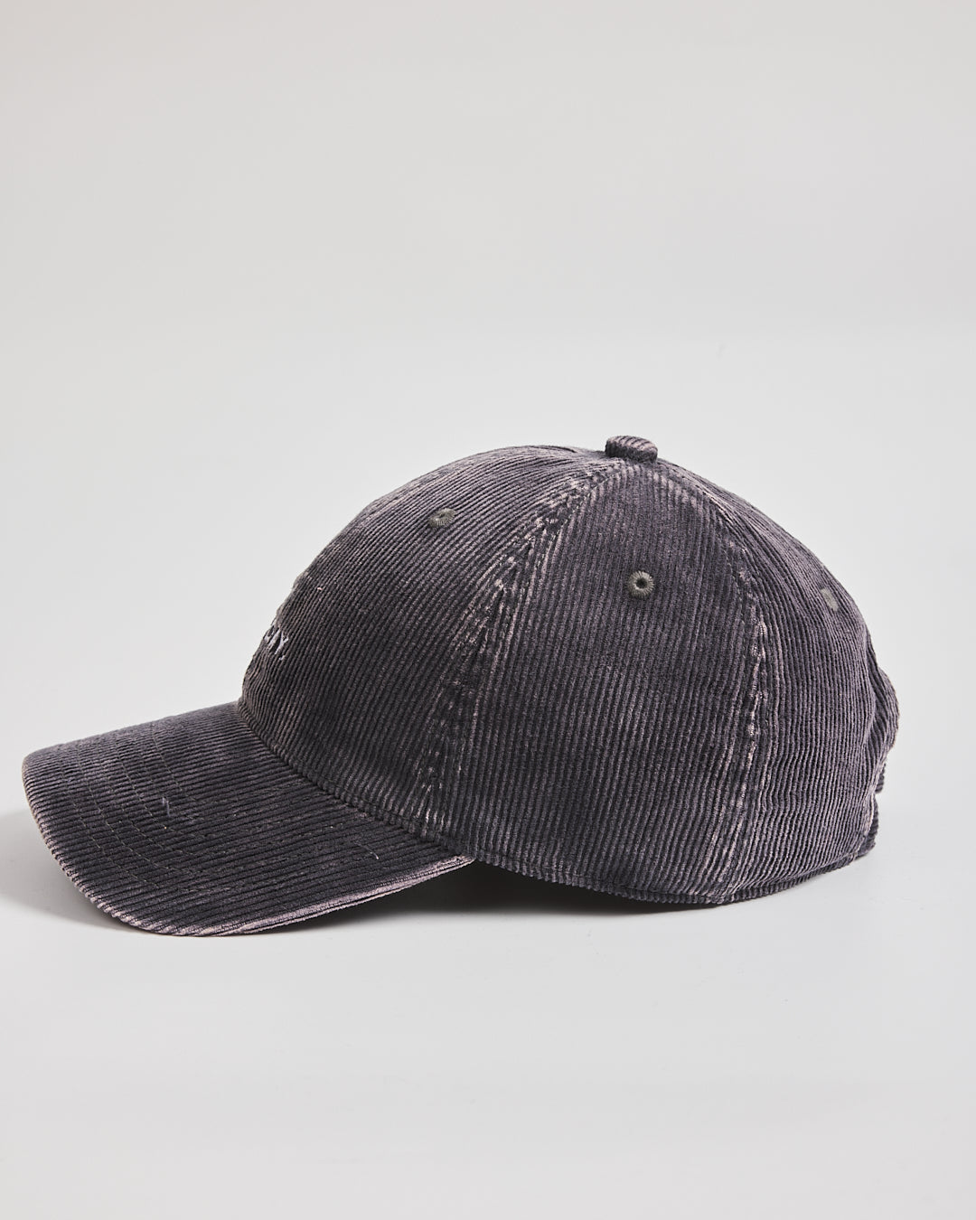 Black corduroy cap on a light gray background