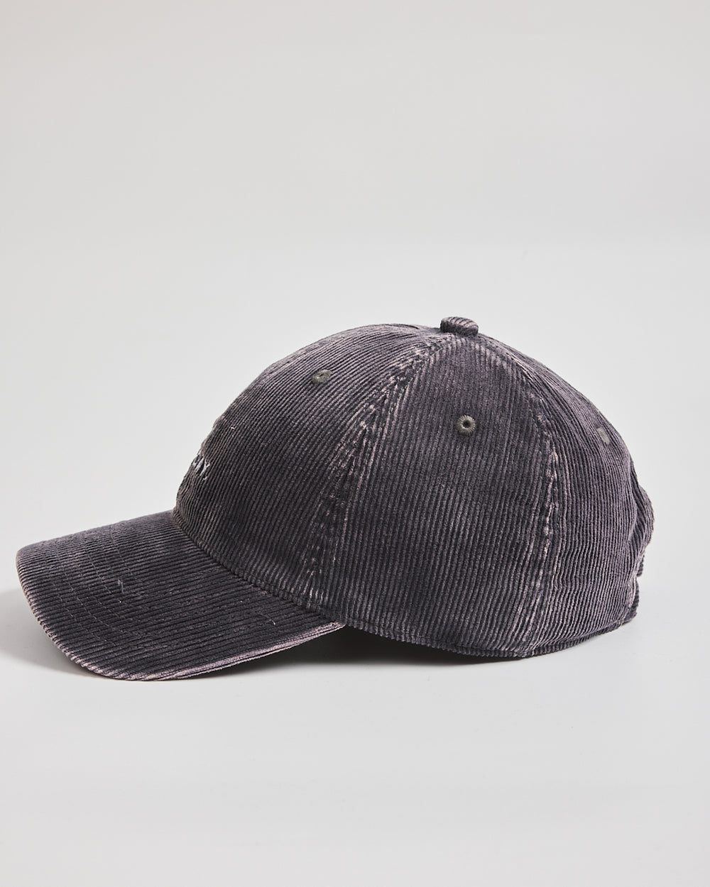 Black corduroy cap on a light gray background