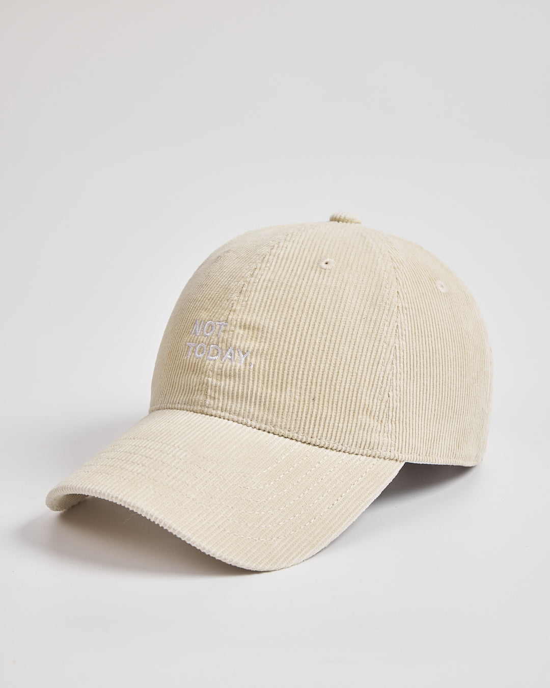 Cream cap with text on a light gray background