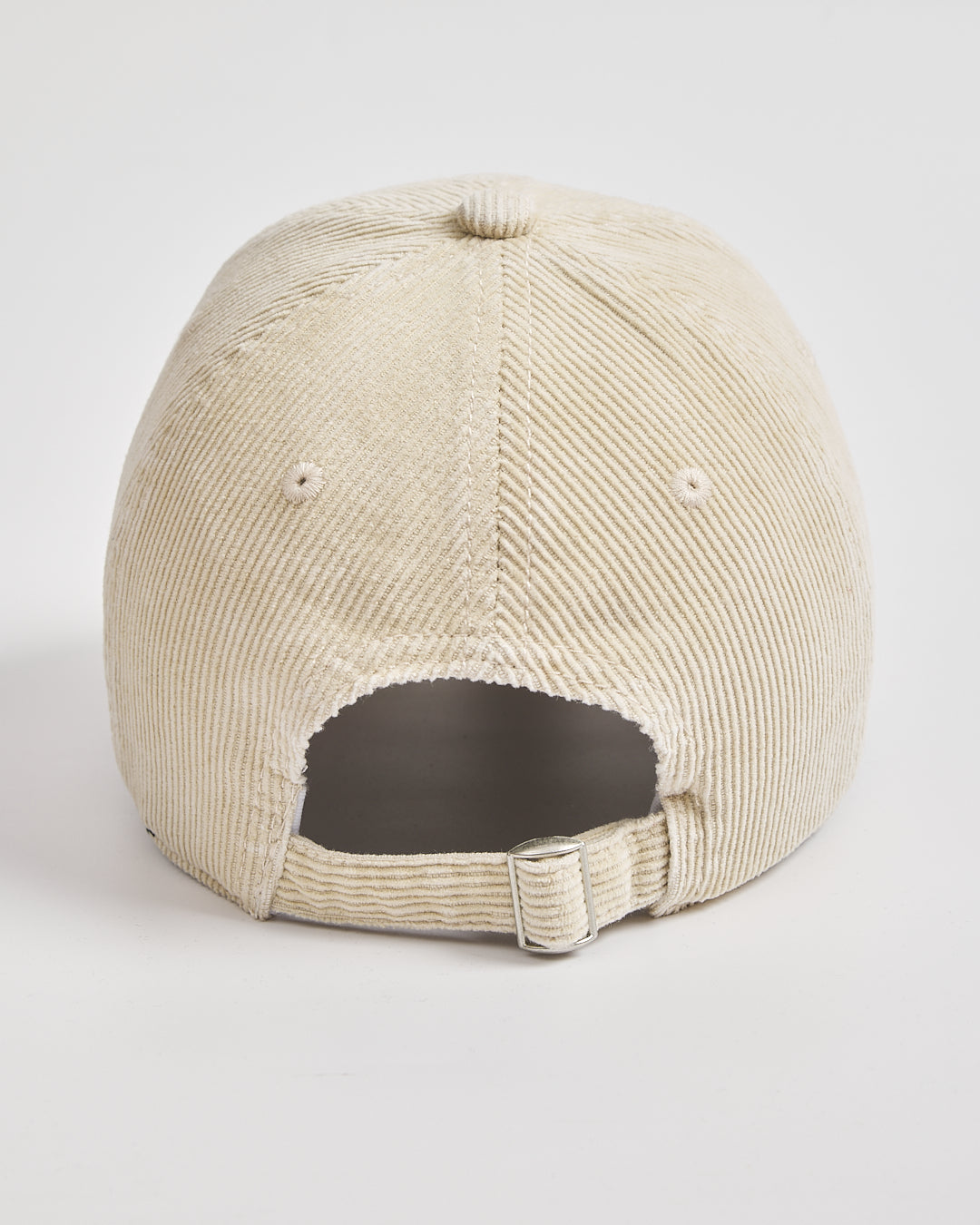 Cream corduroy cap on a light gray background