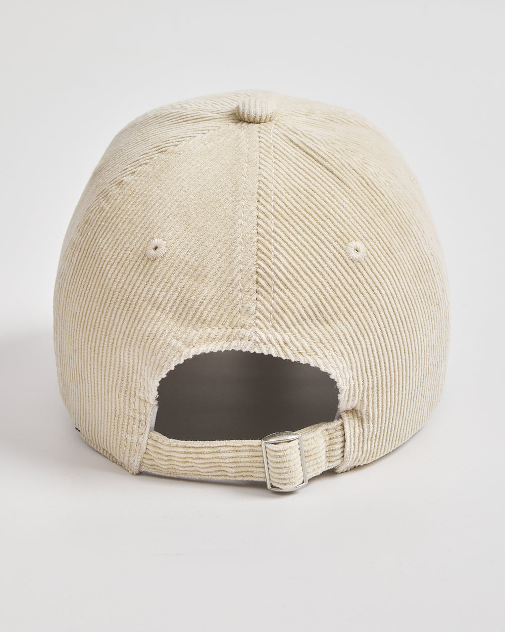 Cream corduroy cap on a light gray background