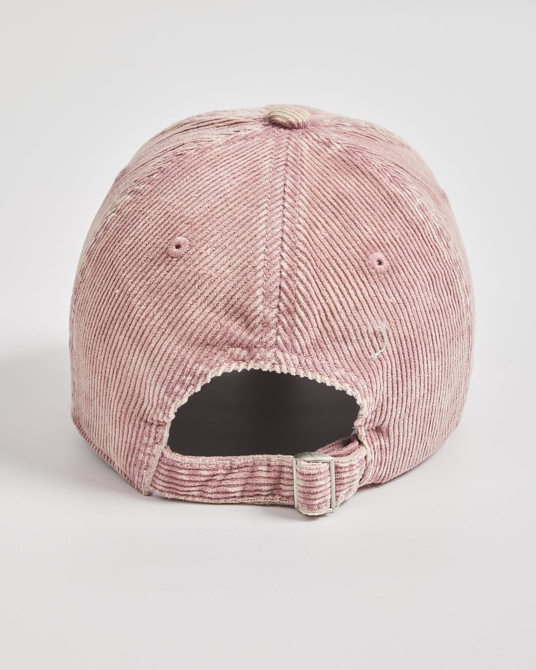 Pink corduroy cap on a light gray background