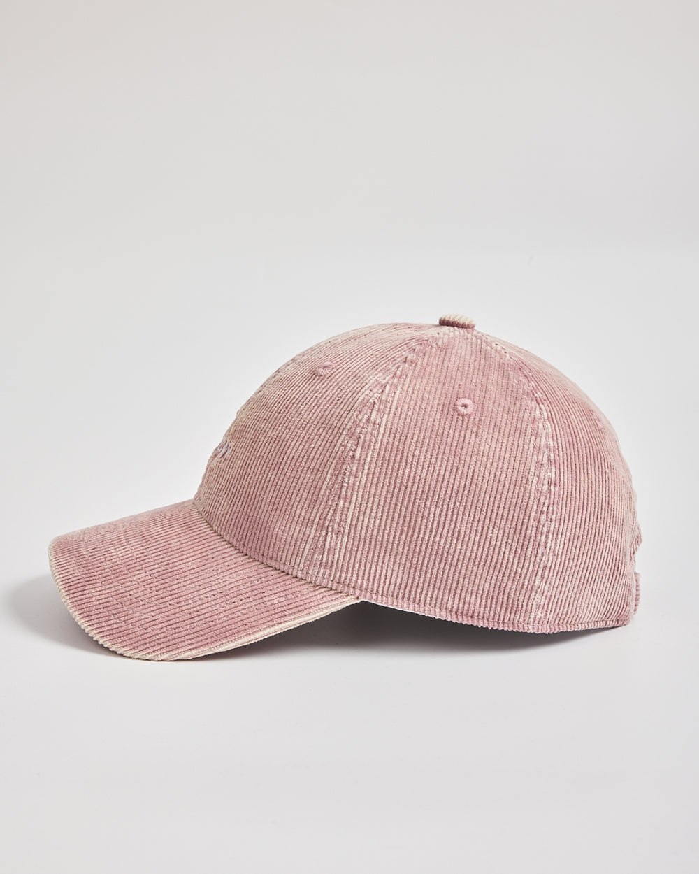 Pink corduroy cap on a light gray background