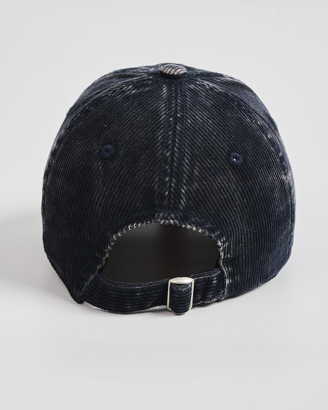 Navy distressed baseball cap on a light gray background