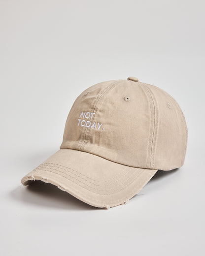 Beige cap with 'Not Today' text on a light gray background