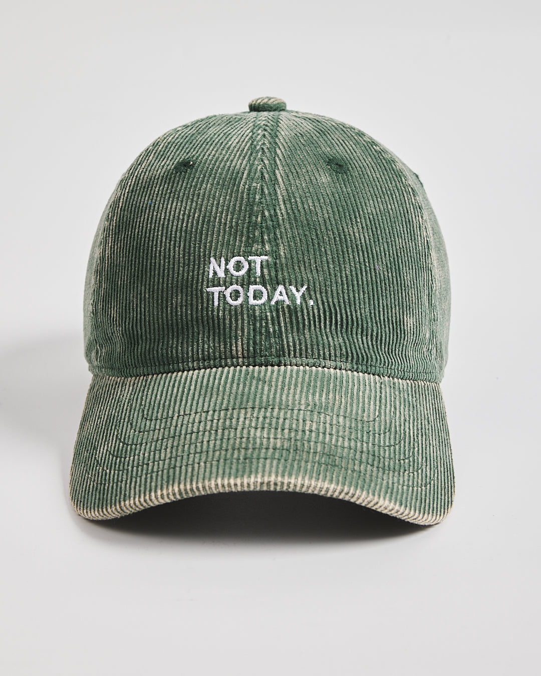Green corduroy cap with 'Not Today' text on a light gray background