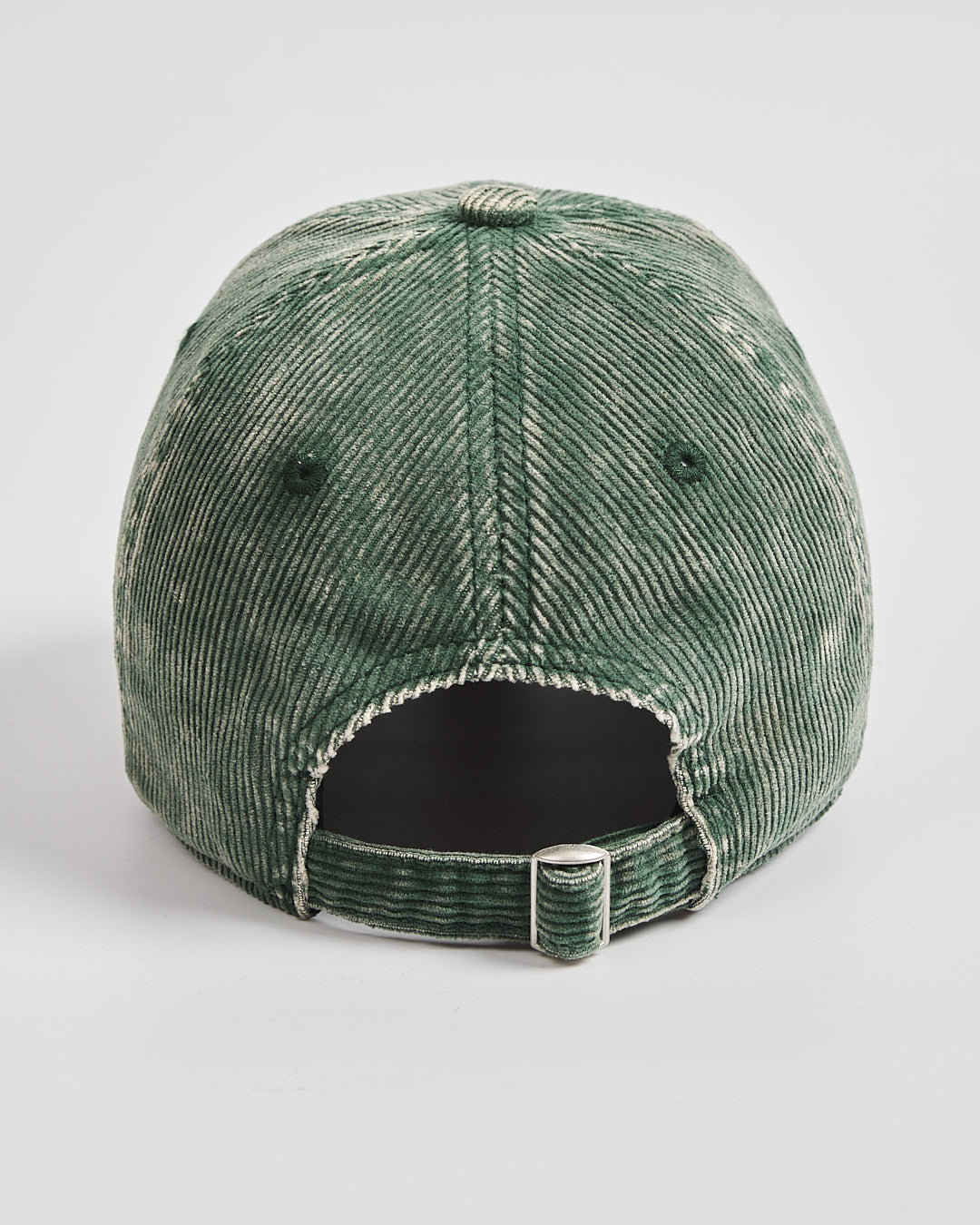 Green distressed baseball cap on a light gray background