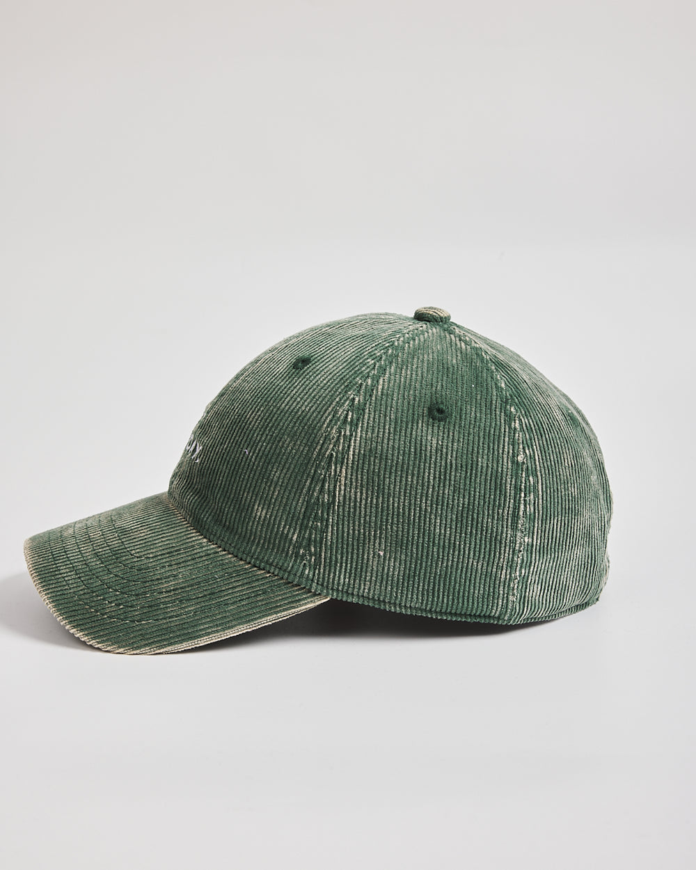 Green corduroy cap on a light gray background