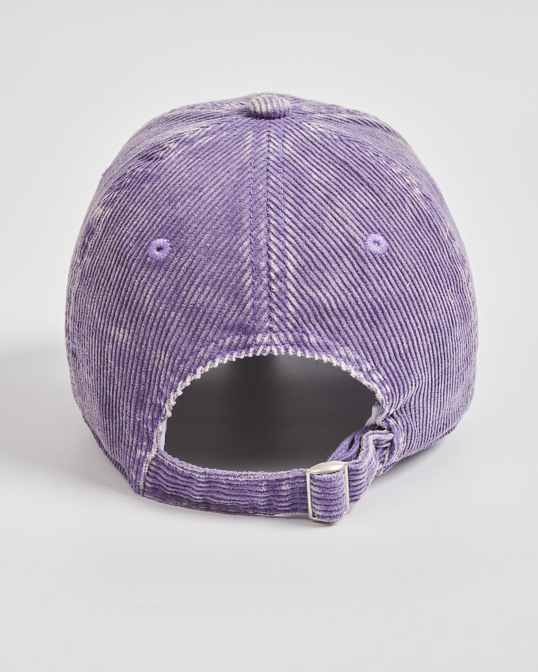 Purple distressed baseball cap on a light gray background