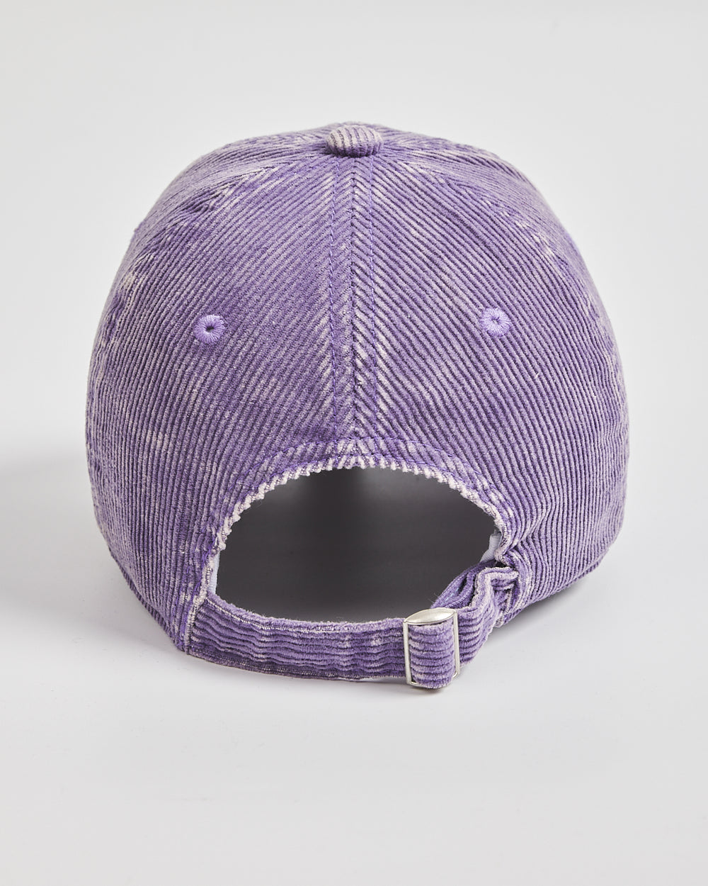 Purple distressed baseball cap on a light gray background