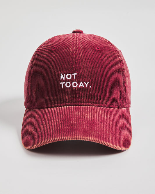 Red corduroy cap with 'Not Today' text on a light gray background