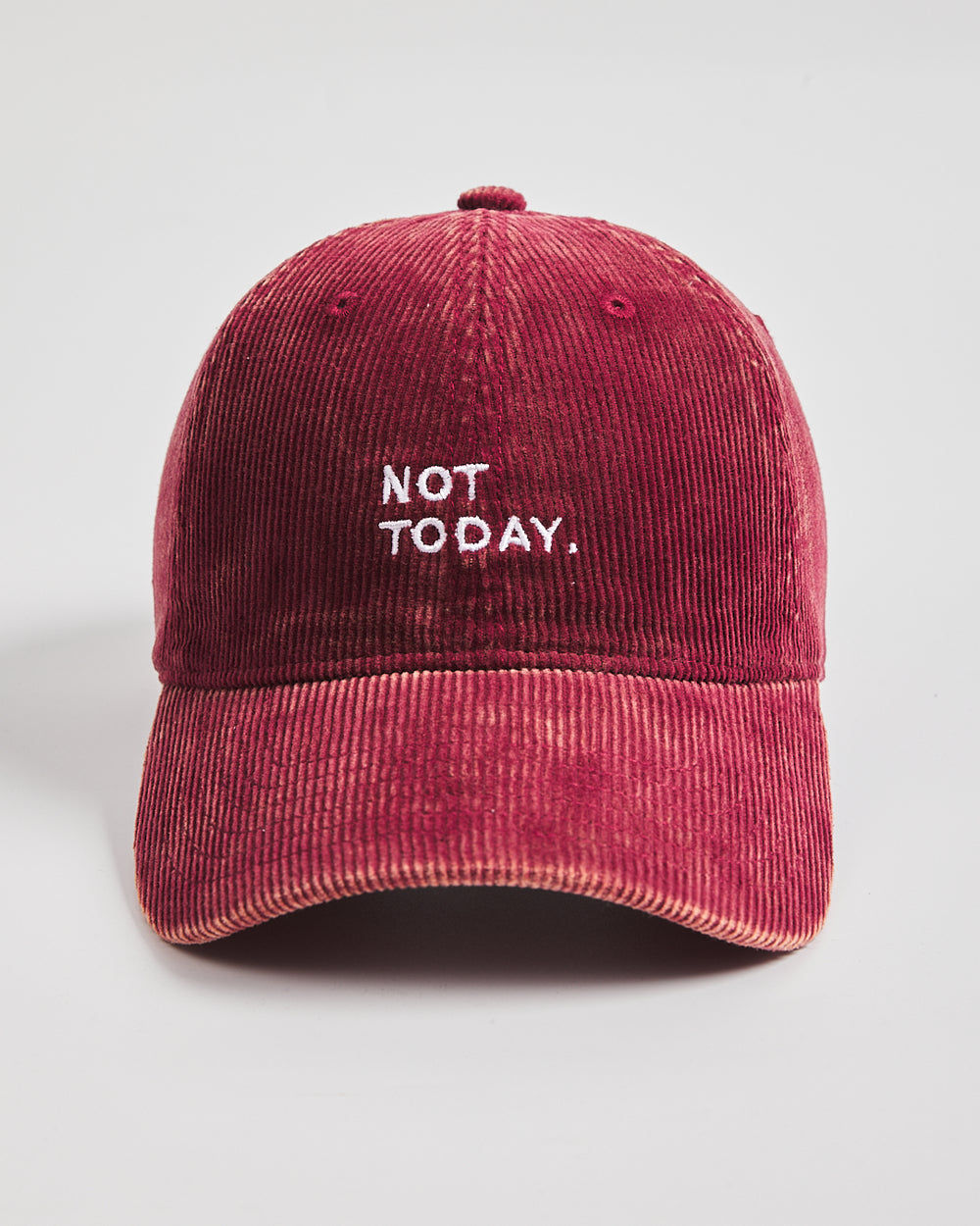 Red corduroy cap with 'Not Today' text on a light gray background