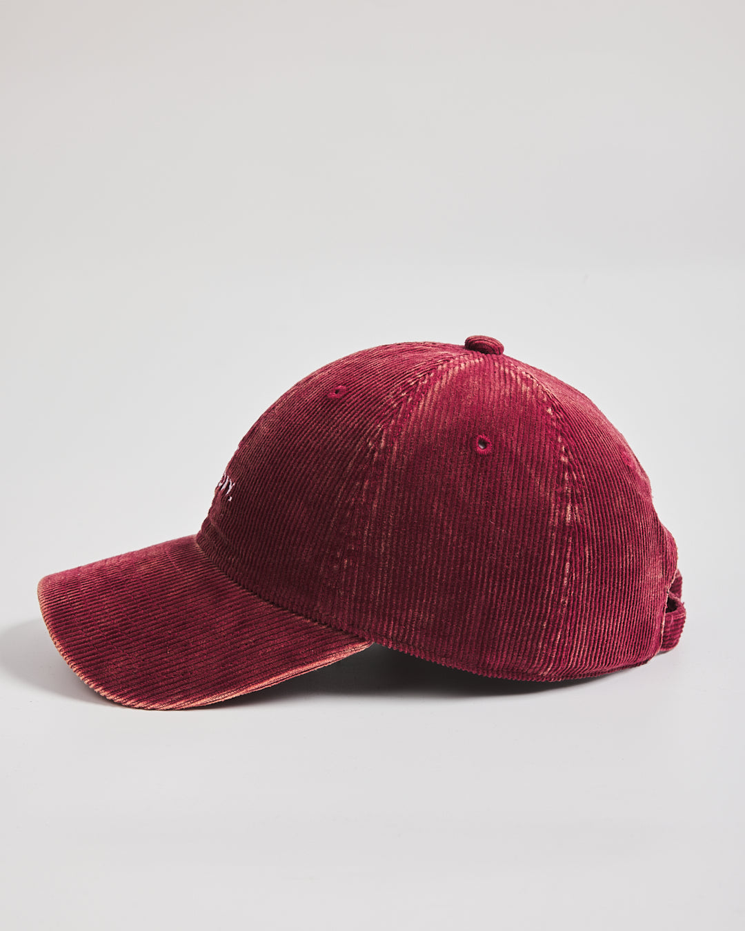 Maroon corduroy cap on a light gray background