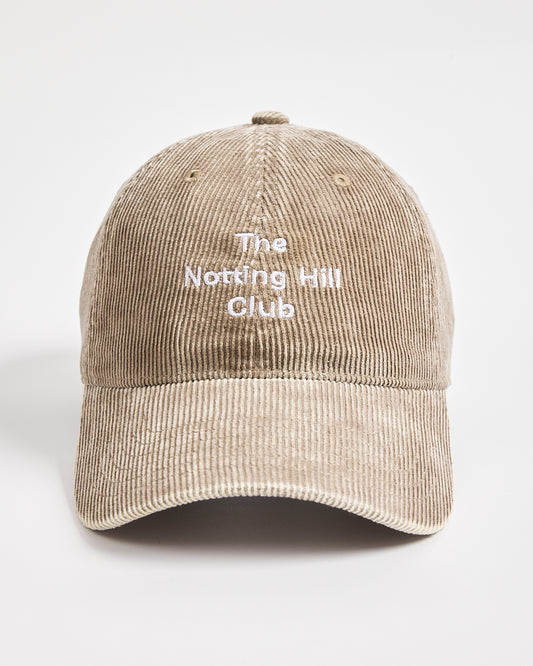 Beige cap with 'The Notting Hill Club' text on a light gray background