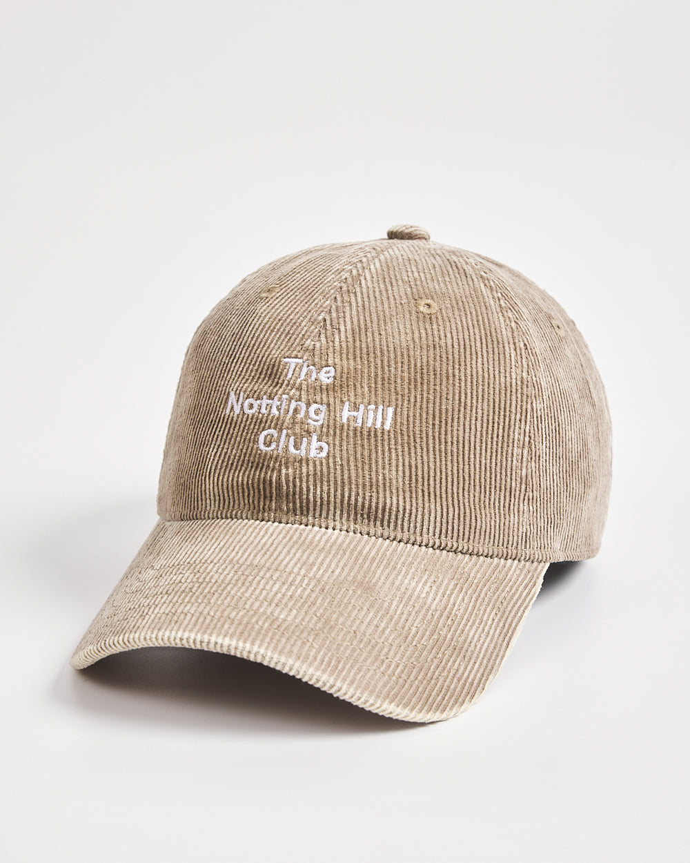 Beige cap with 'The Notting Hill Club' text on a light gray background
