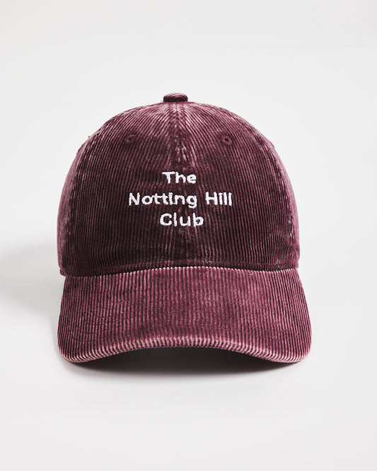 Maroon cap with 'The Notting Hill Club' text on a light gray background
