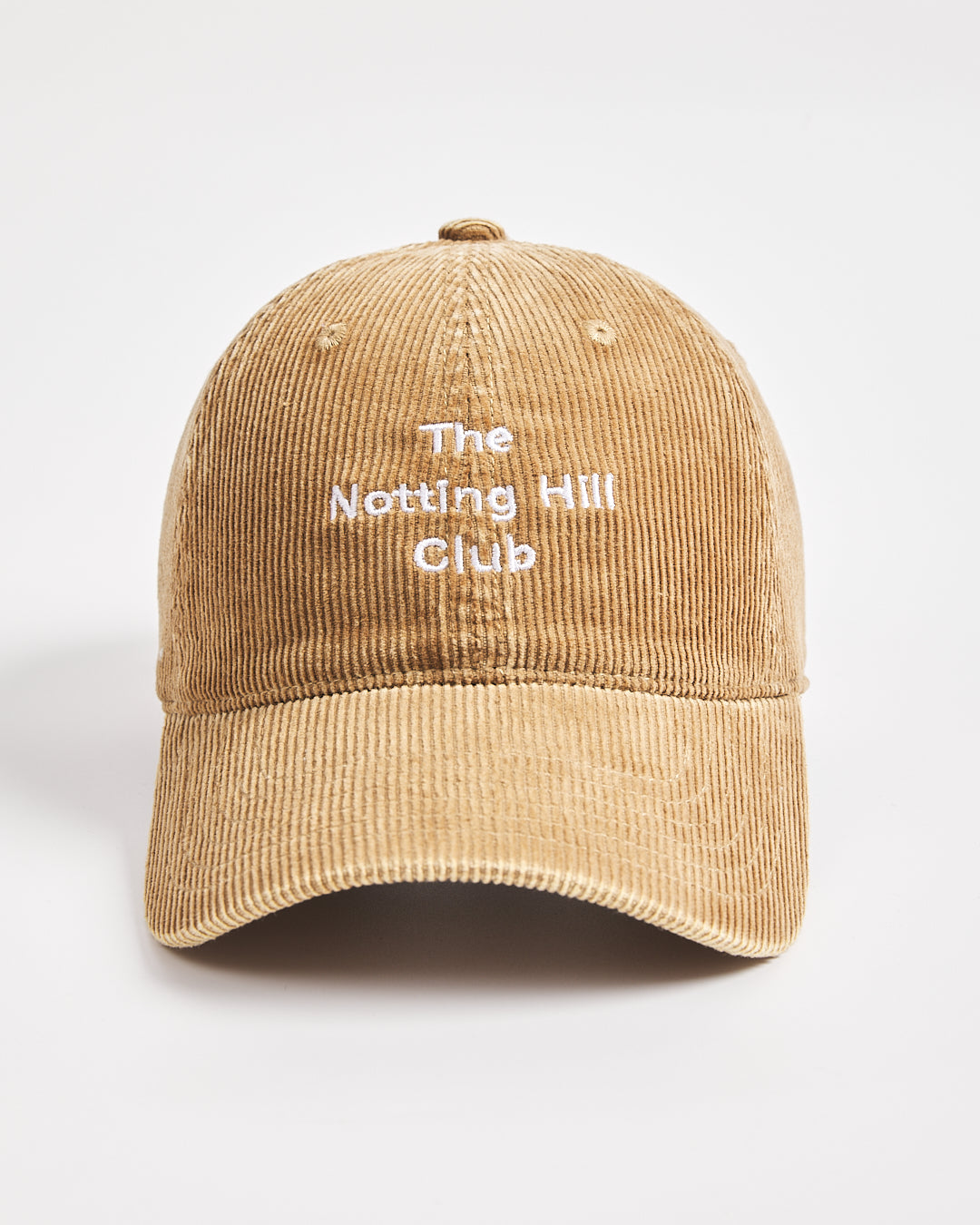 Camel cap with 'The Notting Hill Club' text on a light gray background