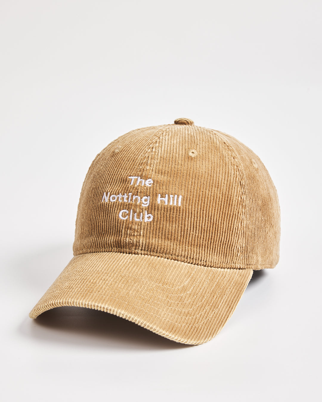Camel cap with 'The Notting Hill Club' text on a light gray background