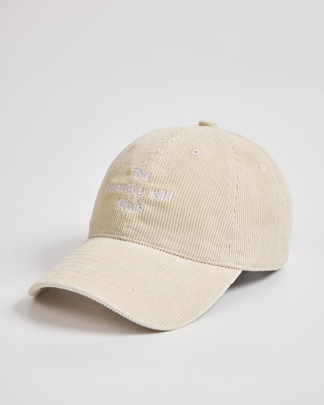 Cream cap with text on a light gray background